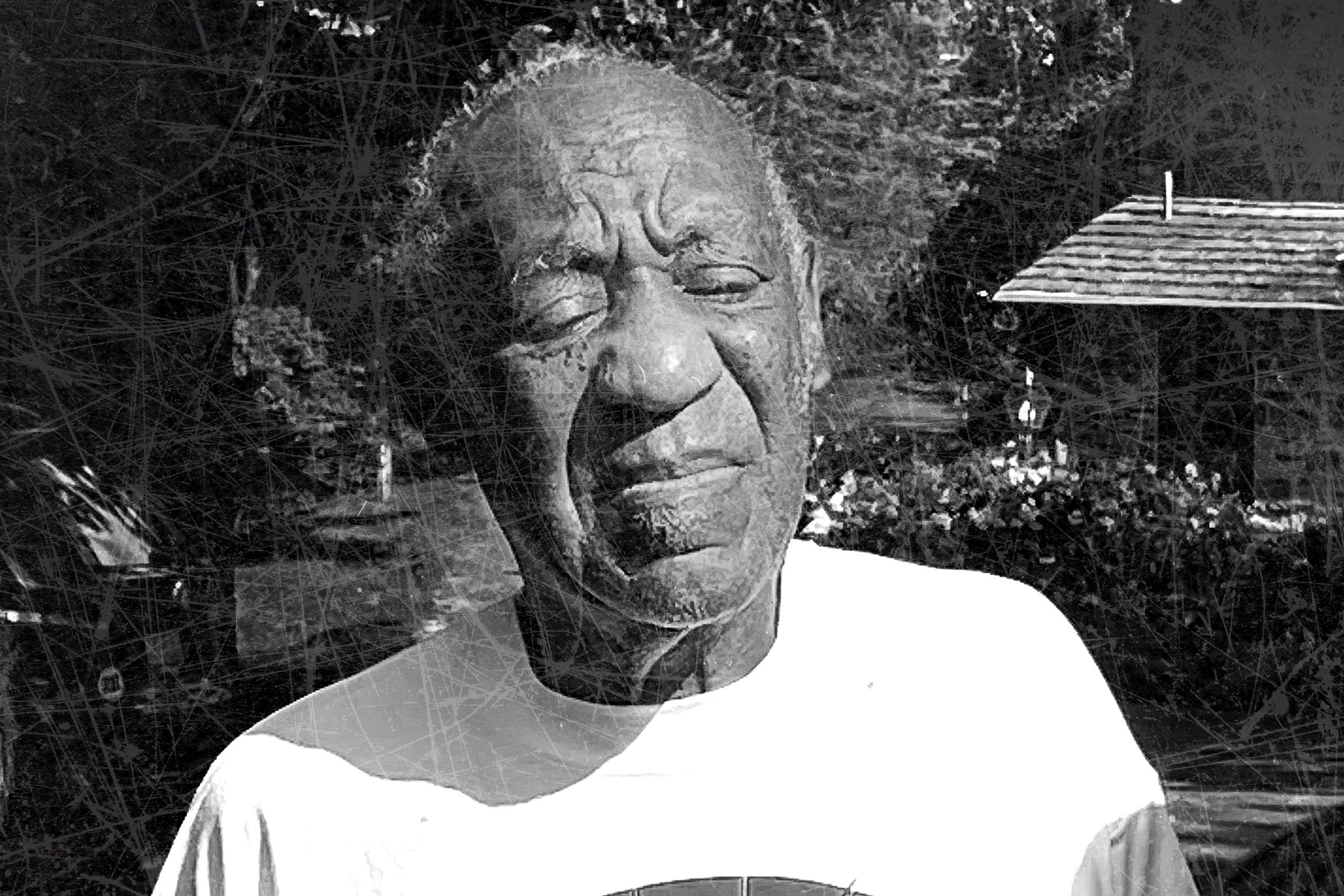 Bill Cosby is seen against a dark, woodsy black-and-white background with a shack to the right side.