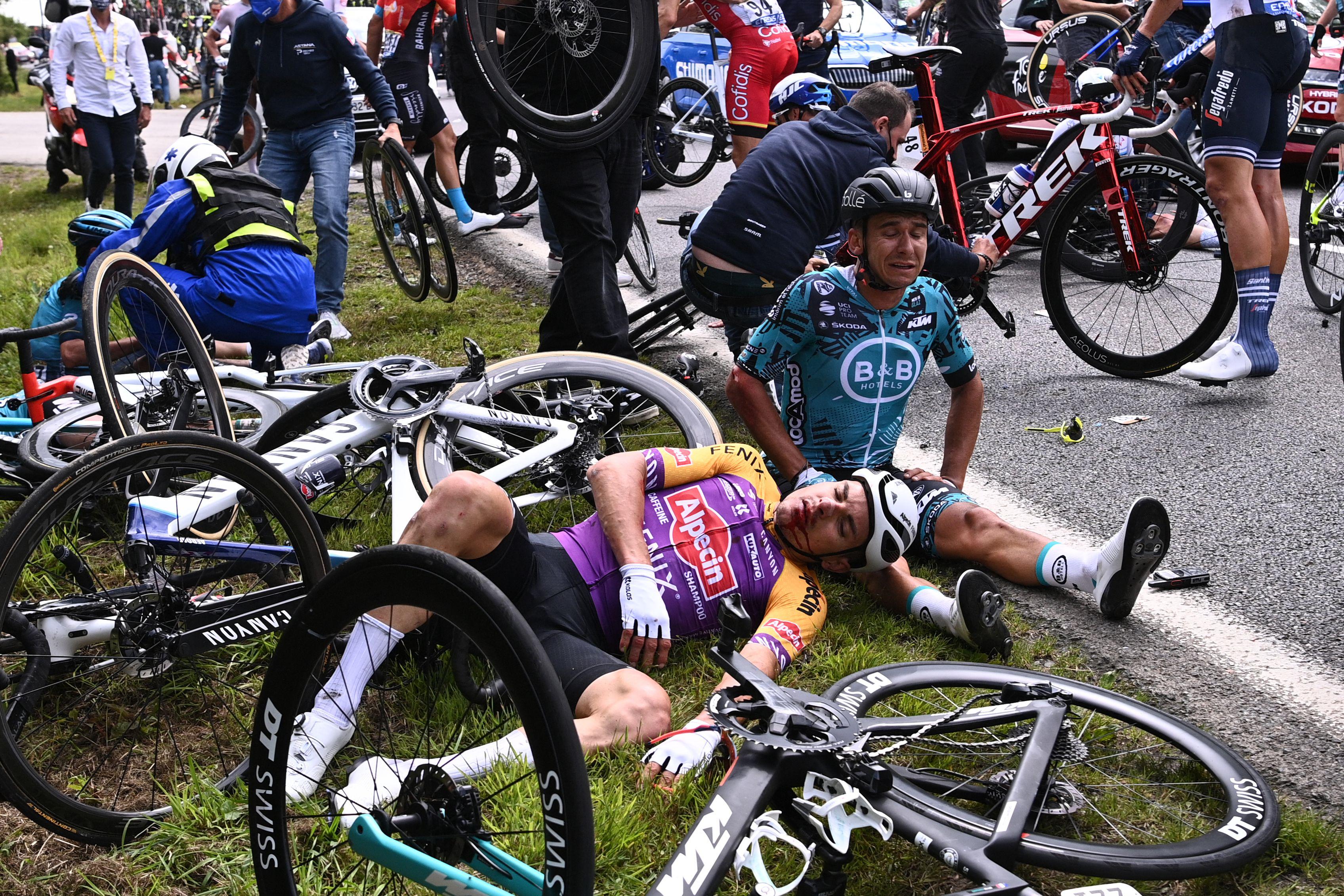 Riders side and lay on the ground besides their crashed bikes.