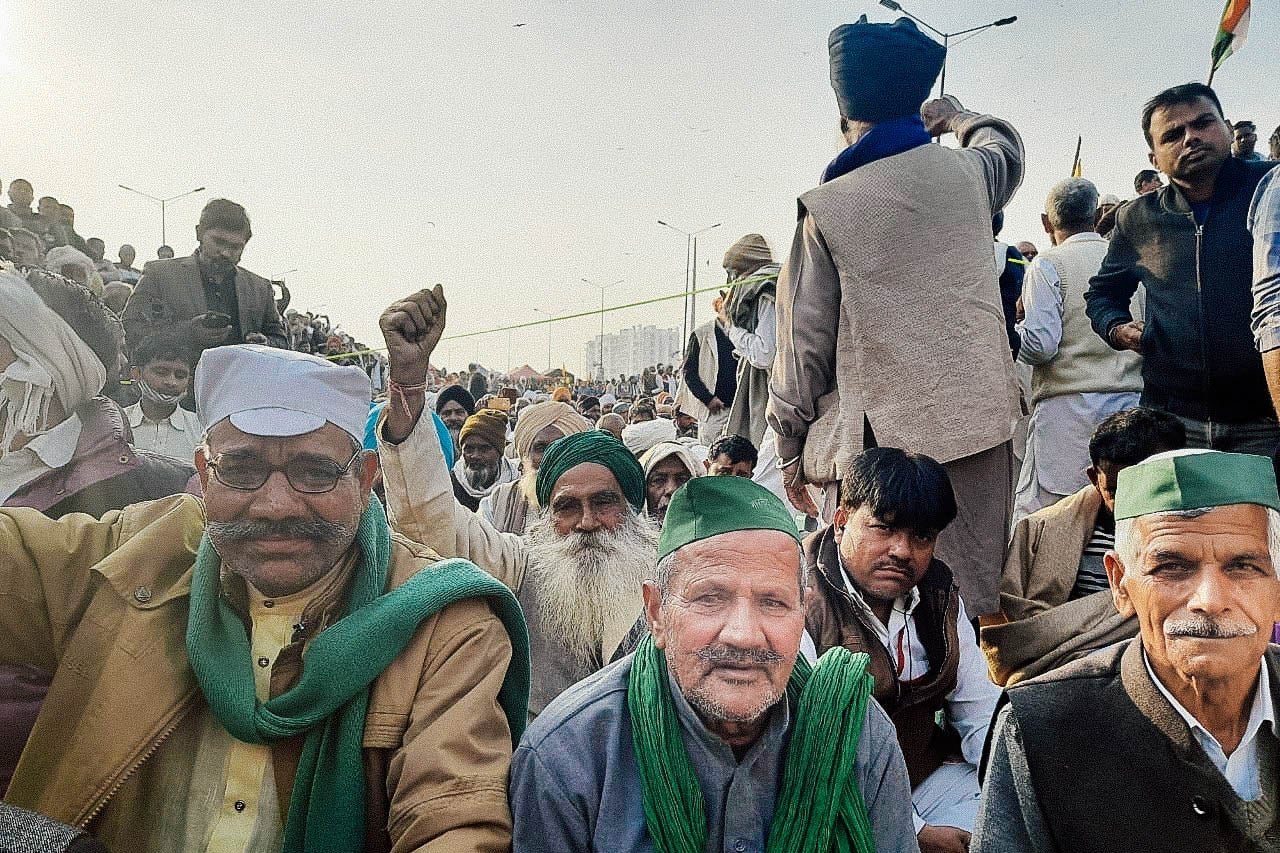 A crowd of men raise their fists.