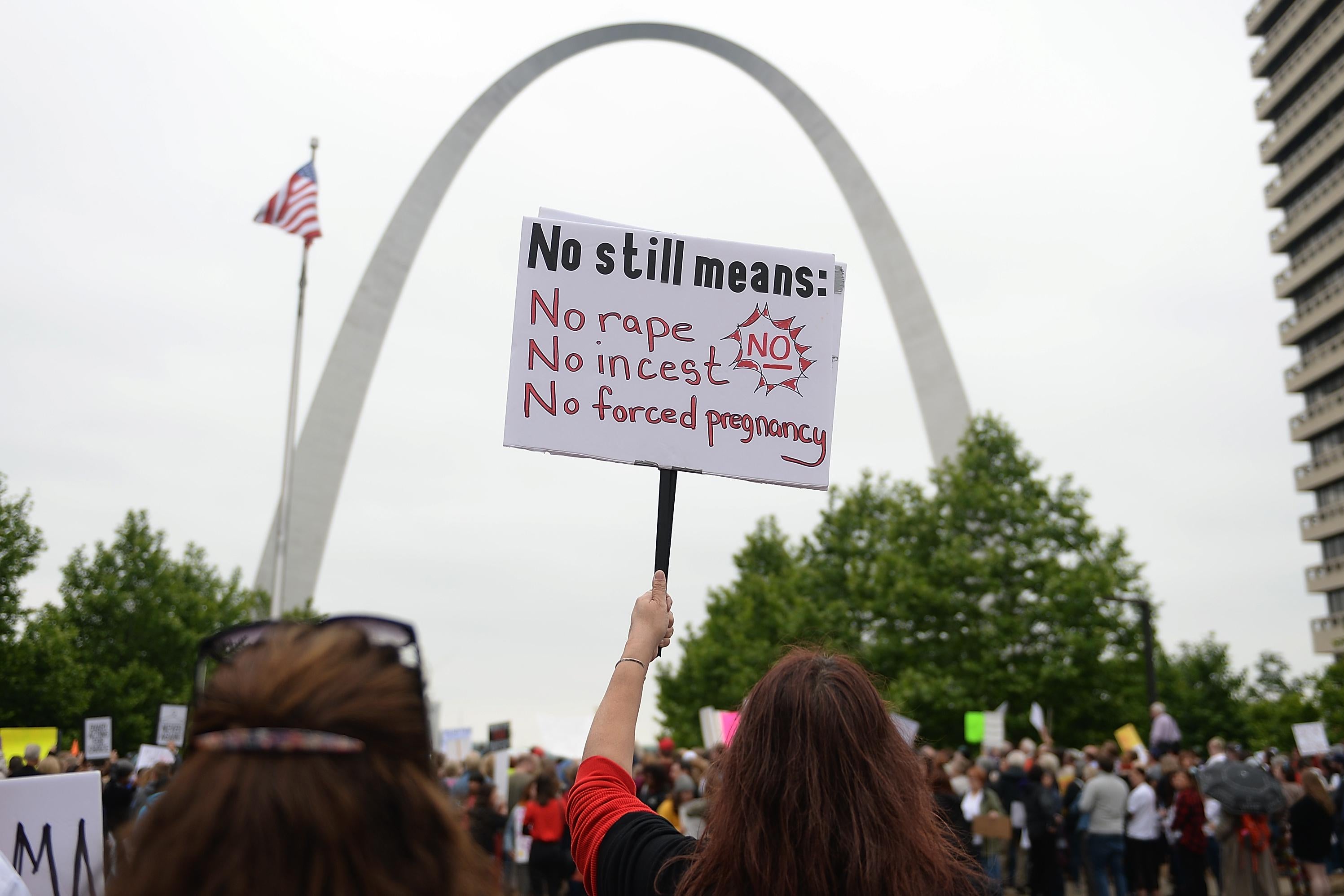 A demonstrator displays a sign during an abortion rights rally in front of the Gateway Arch in St. Louis, Missouri. 