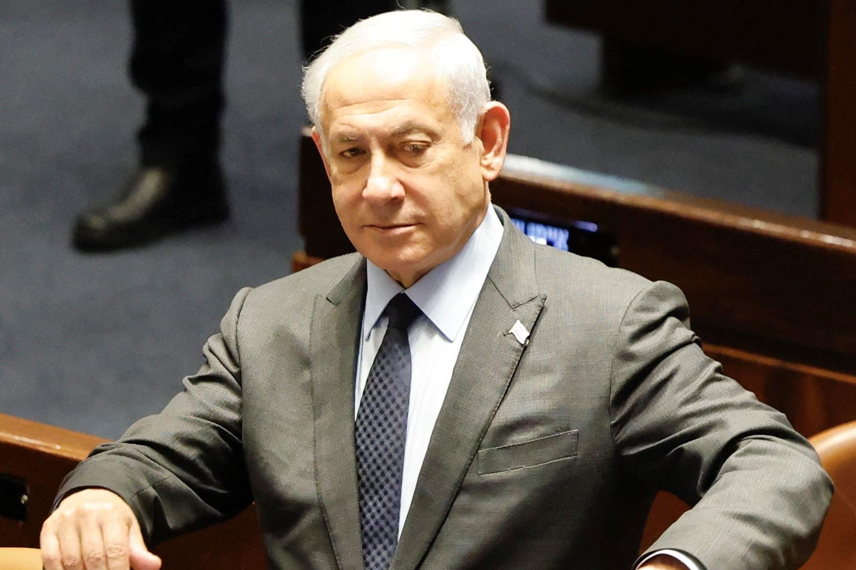 Netanyahu looks down and to the left.