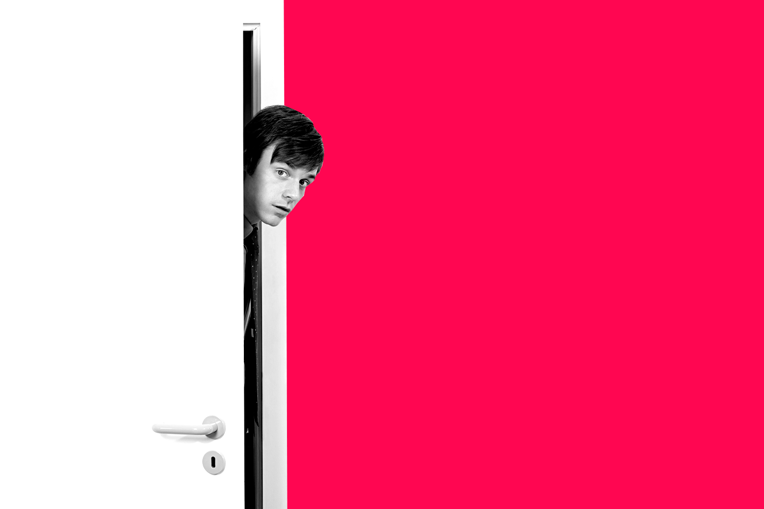 Man peeking his head in from behind a door.