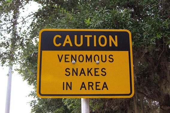 A sign at a Florida Rest Area warns of venomous snakes in the area.