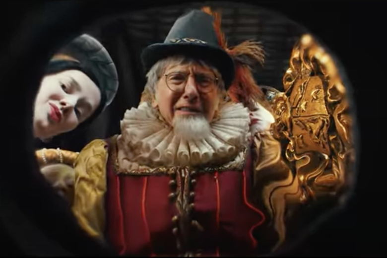 Larry David grimacing in an Elizabethan doublet and ruffs in a commercial for FTX