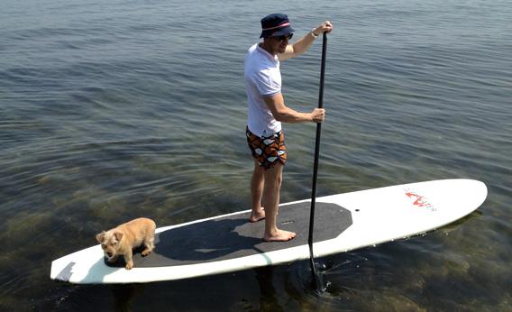 Simon Doonan paddling a paddle board, the trend of the future.