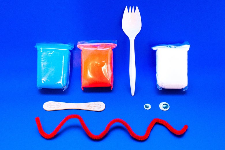 Three packets of clay, a spork, a popsicle stick, two googly eyes, and a red pipe cleaner.
