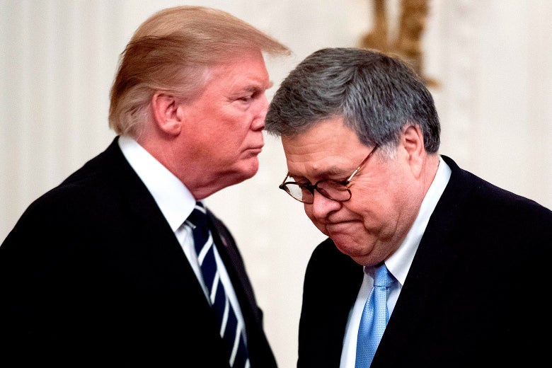 Barr, at right, looks down as he appears to begin walking away from Trump, who is at left.