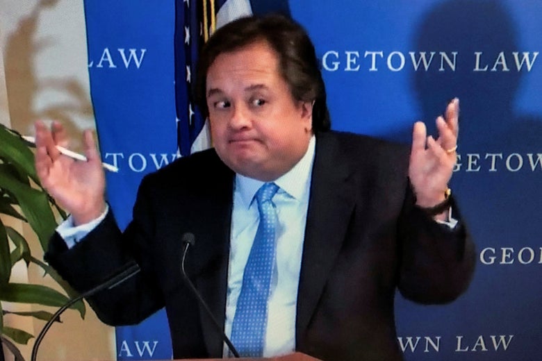 Conway at a podium, shrugging broadly.
