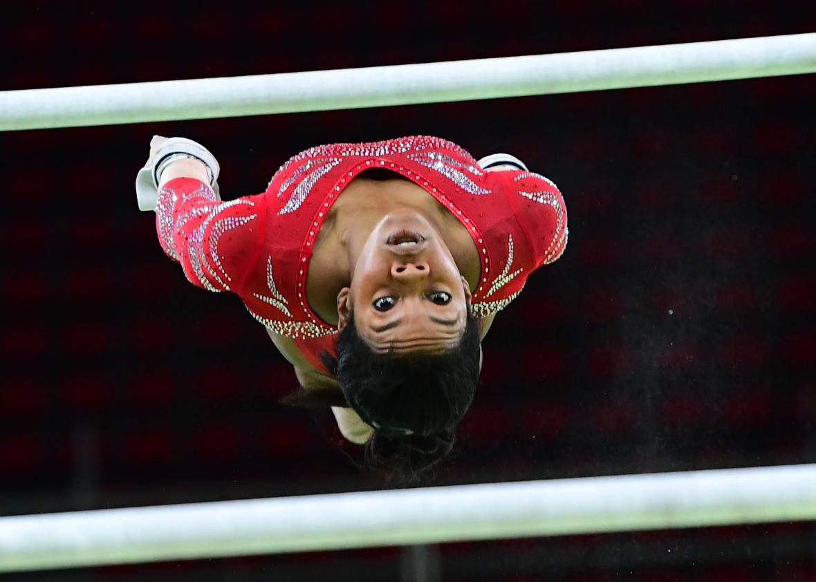 Gabby Douglas competes on the uneven bars.