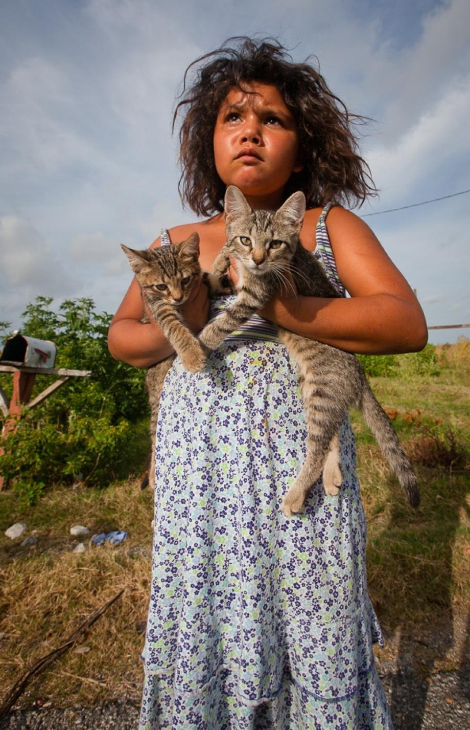 Member of the Biloxi-Chimacha-Choctaw tribe on Isle de Jean Charles with kittens.