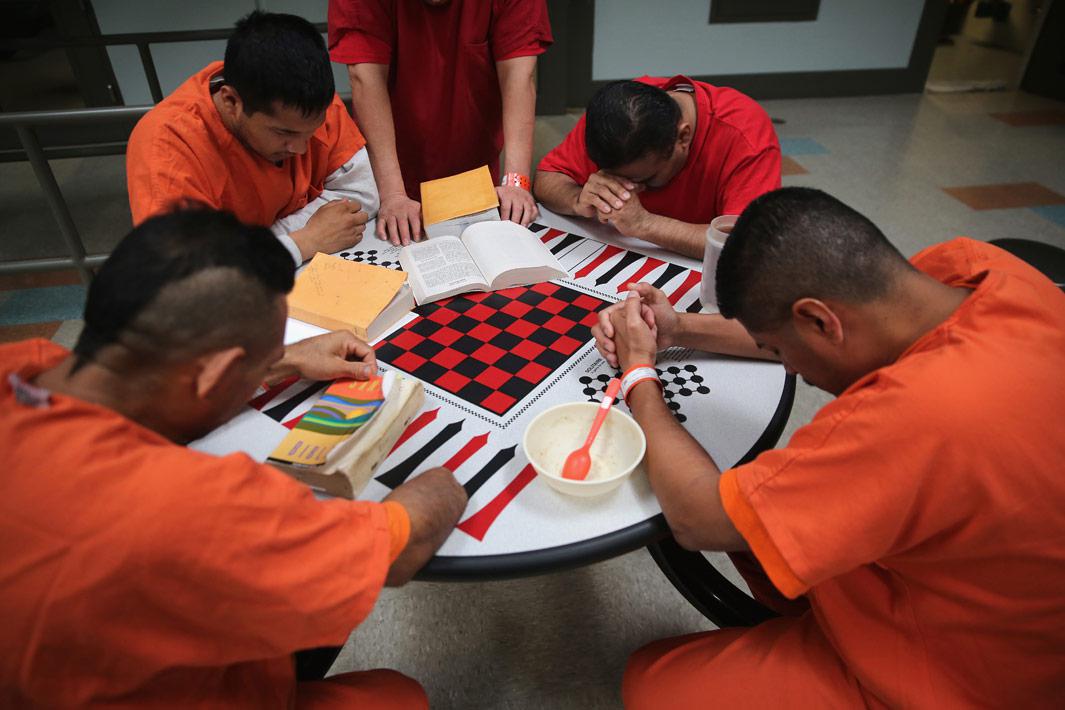 Adelanto, Calif. Immigrant detainees pray during a prayer group in a general population block at the Adelanto Detention Facility on November 15, 2013 in Adelanto, Calif. The facility, the largest and newest Immigration and Customs Enforcement (ICE), detention center in California, houses an average of 1,100 immigrants in custody pending a decision in their immigration cases or awaiting deportation. The average stay for a detainee is 29 days. The facility is managed by the private GEO Group. ICE detains an average of 33,000 undocumented immigrants in more than 400 facilities nationwide. 