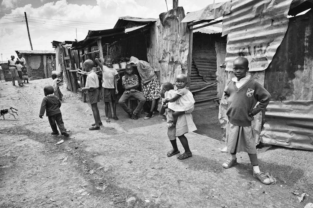NEIGHBORHOOD WATCH:  The title says it all, this at the heart of the slum—everyone watches out for everyone else, including children watching out for other children.