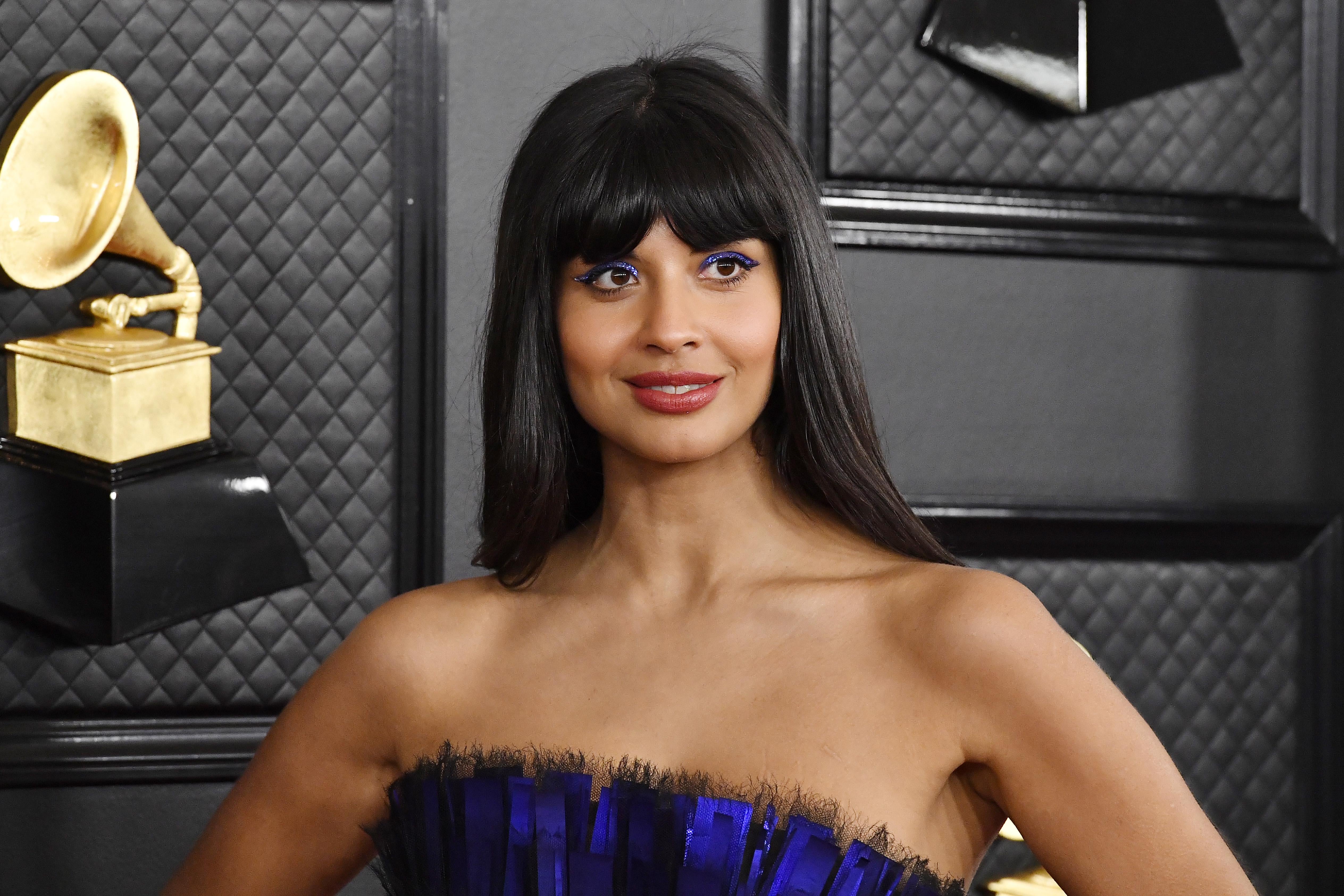 Jameela Jamil in a strapless purple dress on the Grammys red carpet