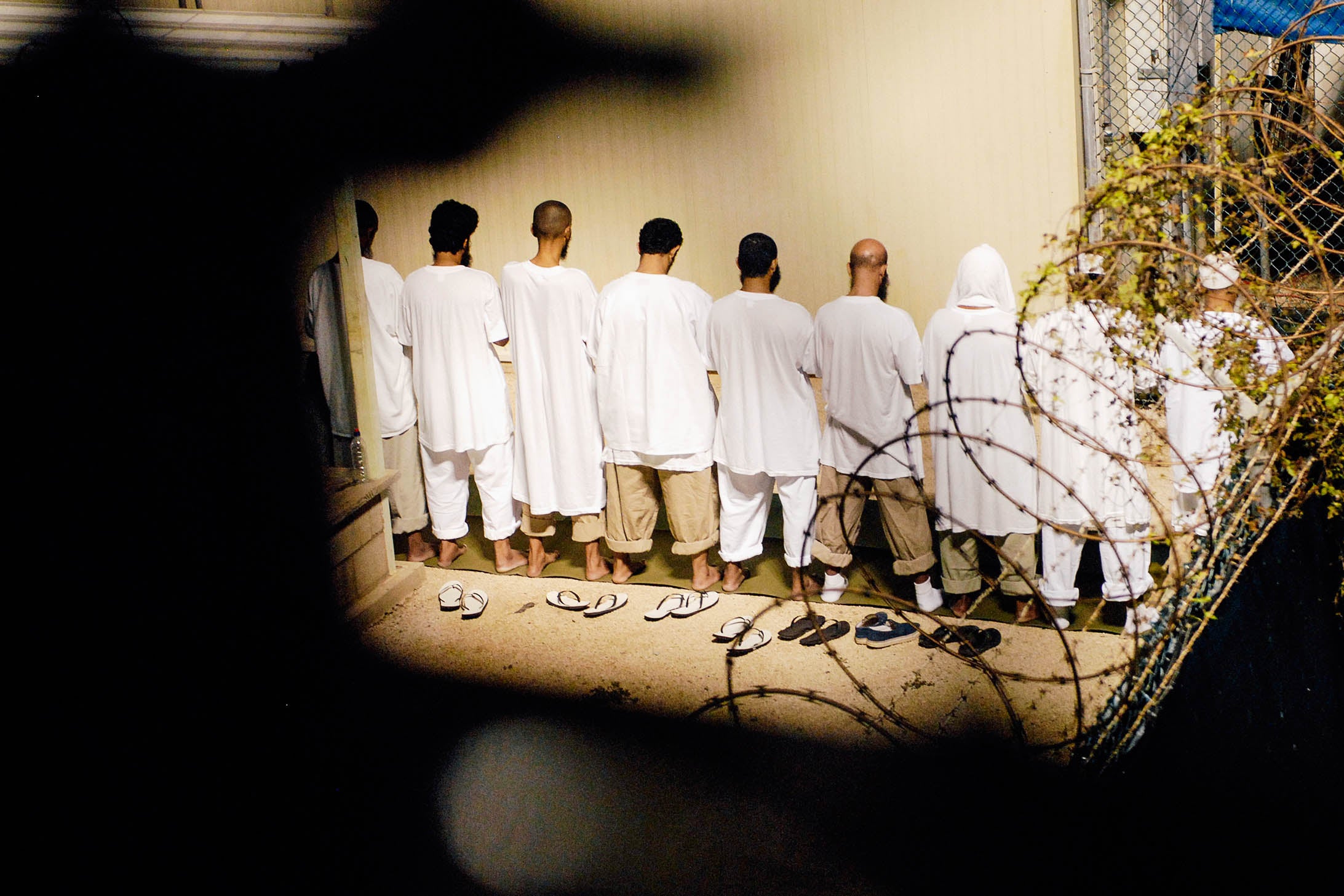 A group of detainees observe morning prayer before sunrise at Guantanamo Bay in an Oct. 28, 2009 file photo provided by the Department of Defense.