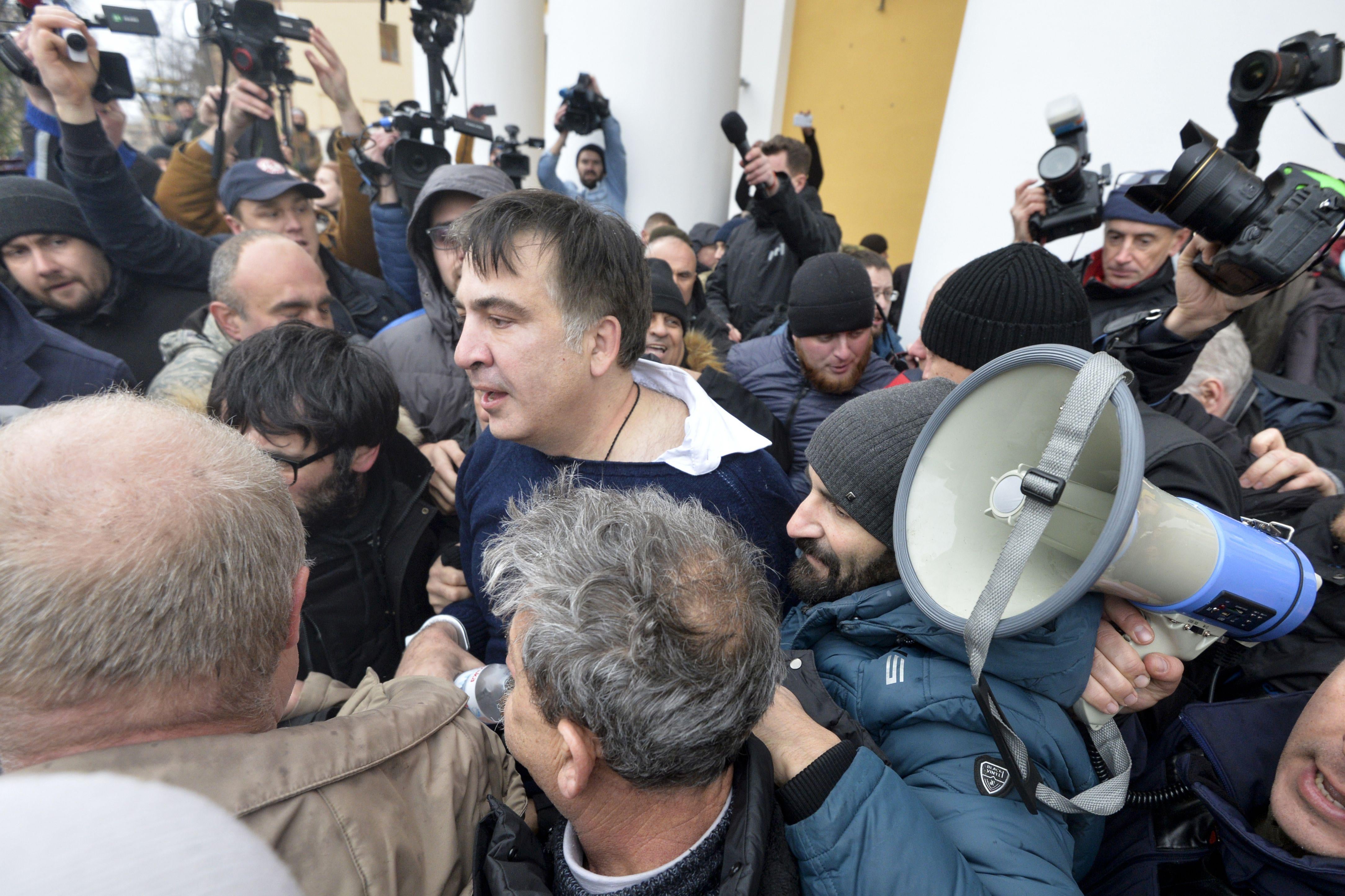 TOPSHOT - Former Georgian Mikheil Saakashvili (C-L) is seen after he was released by his supporters in downtown Kiev on December 5, 2017.
Ukrainian security services on December 5 arrested former Georgian president Mikheil Saakashvili after he climbed onto the roof of his apartment building and addressed supporters during a police raid. The Ukrainian Security Service (SBU) said Saakashvili had been arrested on charges of assisting criminal organisations. / AFP PHOTO / Sergei CHUZAVKOV        (Photo credit should read SERGEI CHUZAVKOV/AFP/Getty Images)