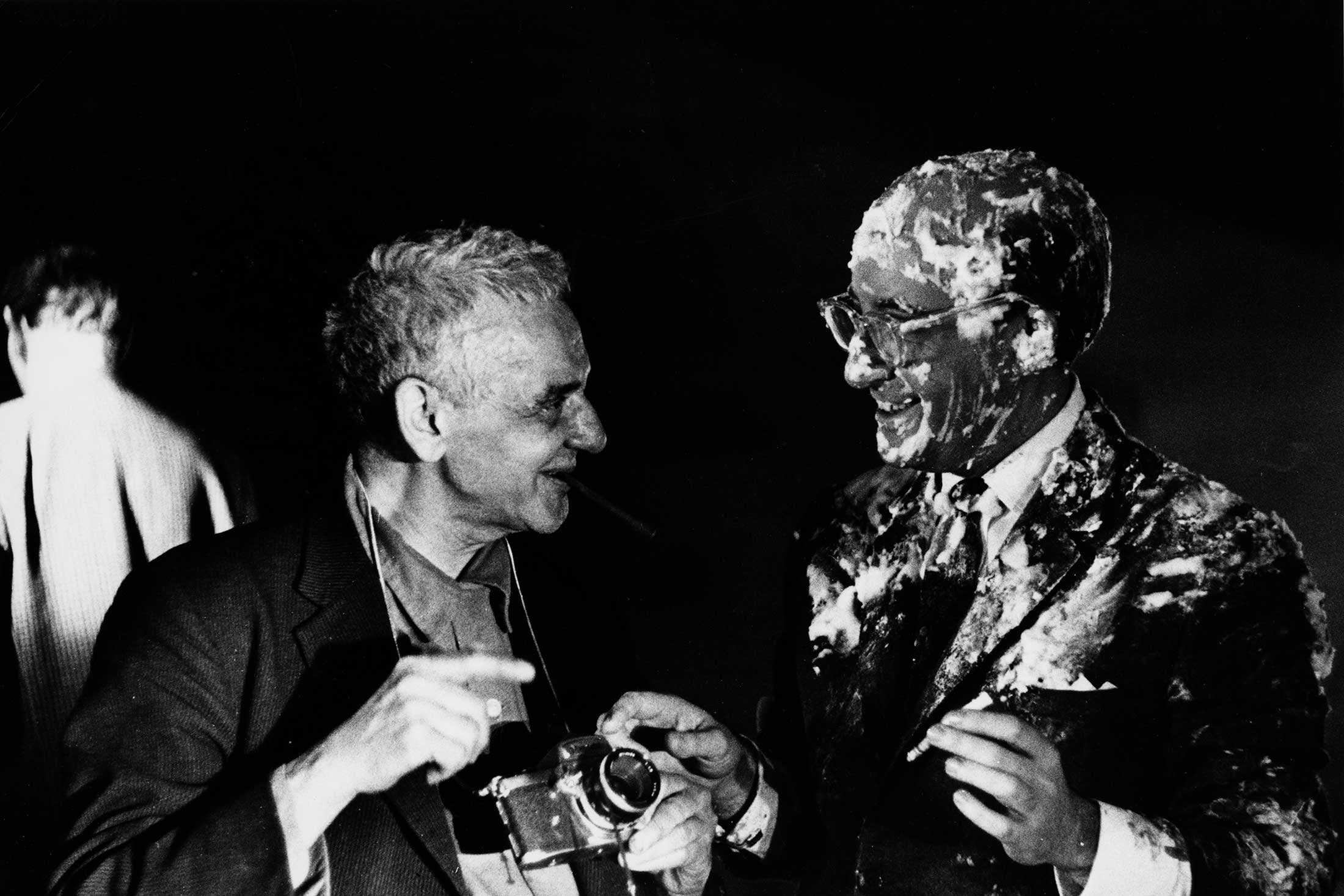 Weegee (left) and Peter Sellers, covered in custard and holding a cigarette, after the pie fight on the set of Dr. Strangelove.