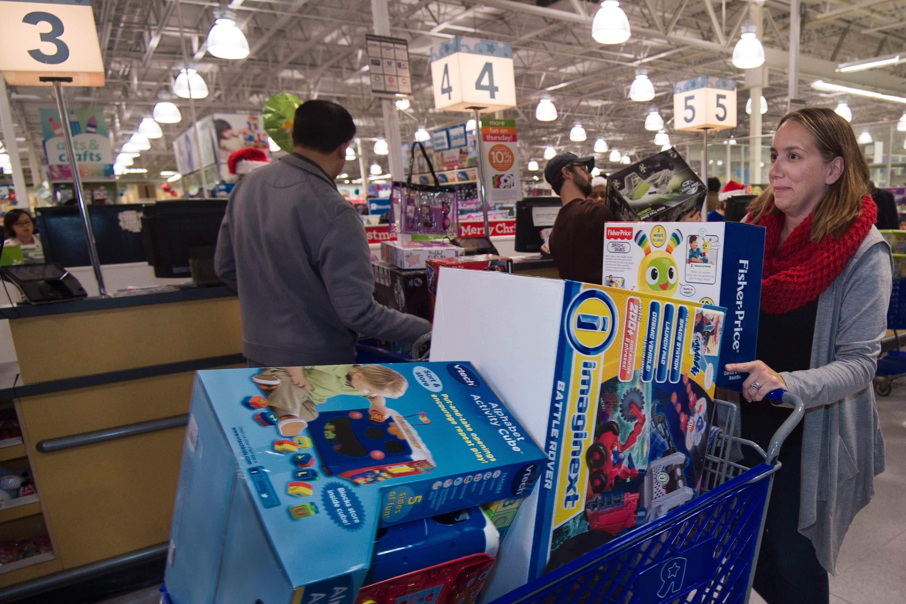A woman pushes her cart full of toys at  a Toys-R-Us store, in Fairfax, Virginia  November 26, 2015, on a Black Friday sale that extended a day earlier into Thanksgiving evening. The  US holiday shopping season kicks off with 'Black Friday' -- the day after the Thanksgiving holiday -- with a frenzy expected at stores around the country as retailers slash prices.         AFP PHOTO/PAUL J. RICHARDS / AFP / PAUL J. RICHARDS        (Photo credit should read PAUL J. RICHARDS/AFP/Getty Images)