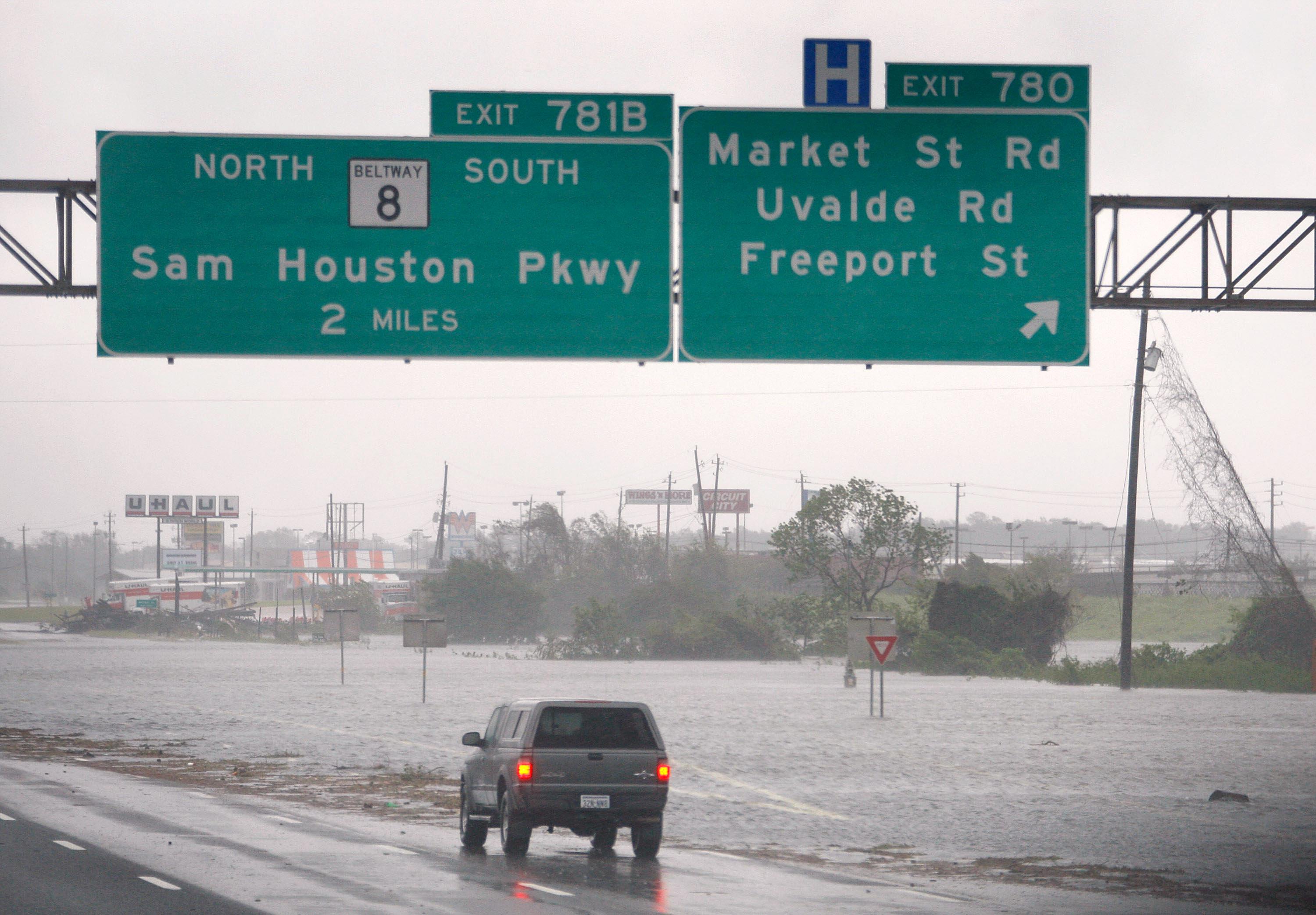 A driver surveys a stretch of Interstate 10 flooded by Hurricane Ike, Sept. 13, 2008, near Houston.