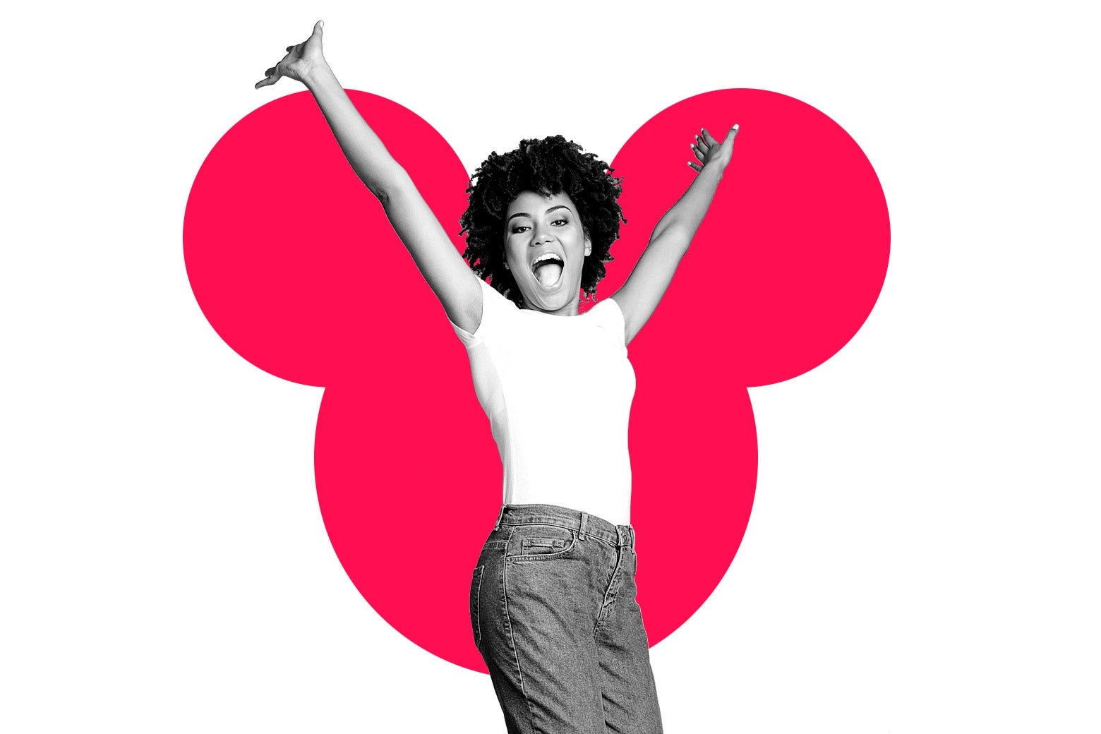 A woman jumps for joy in front of the Mickey Mouse symbol
