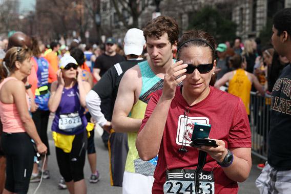 Runners react near Kenmore Square after two bombs exploded during the 117th Boston Marathon.