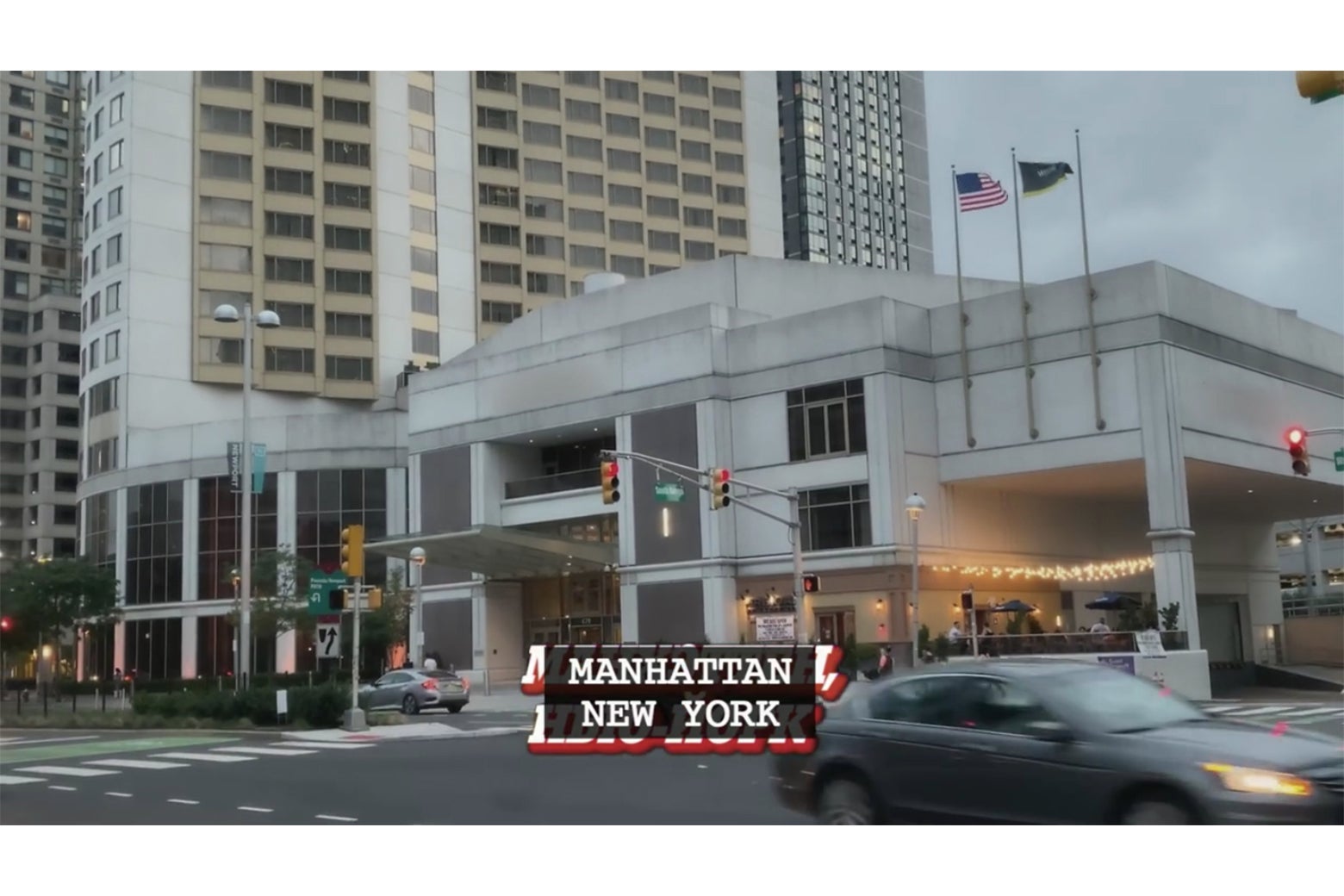 An establishing shot from Borat of the exterior of a large hotel, with the caption "Manhattan, New York"