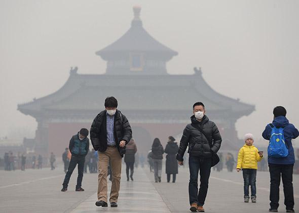 People wearing masks walk on Danbi Bridge at the Temple of Heaven Park Beijing, China. 