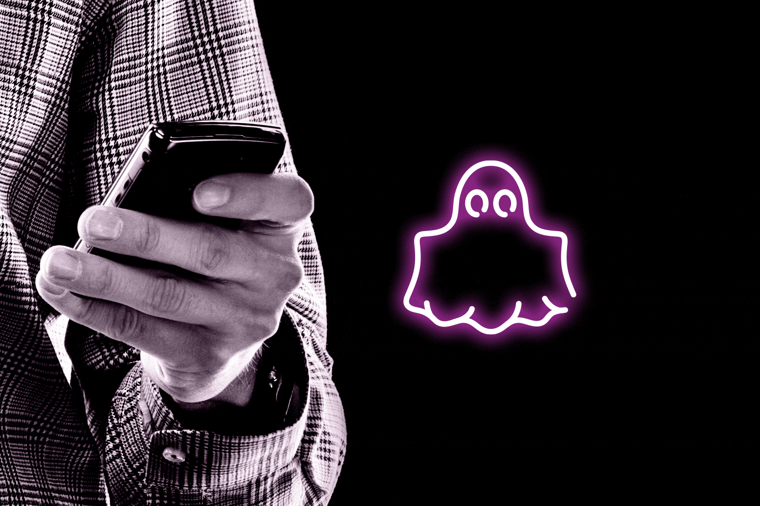 A hand holding a phone, and a graphic of a ghost.