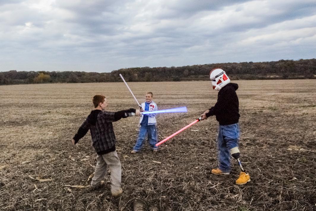 Raymond Hubbard with his children, Brady and Riley. Since his injuries, Raymond has become an avid collector of Star Wars memorabilia. This is one of several family photos I took at Raymond’s request.DARIEN, WISCONSIN. USA. 2007