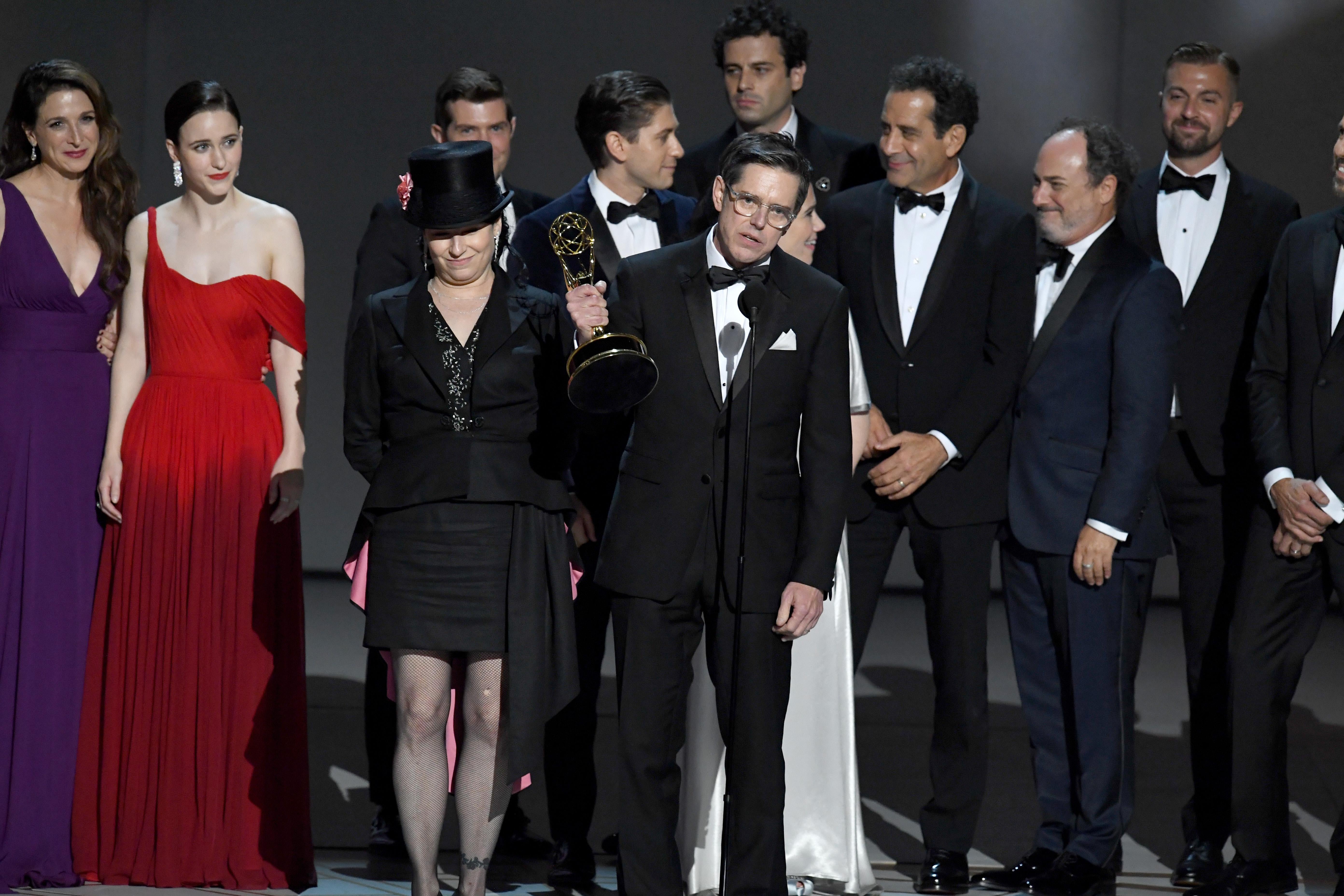 Amy Sherman-Palladino and Daniel Palladino and cast and crew accept the award onstage.
