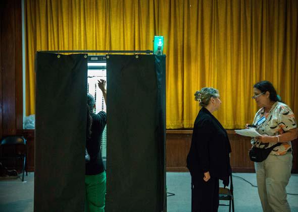 A woman votes at a polling station on September 10, 2013.