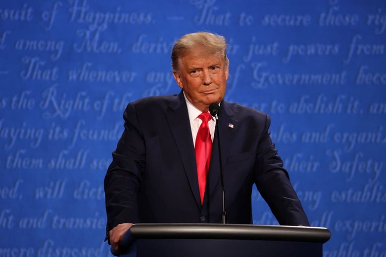 Trump, standing with his arms on his lectern, looks to his right with an expression of subdued annoyance.