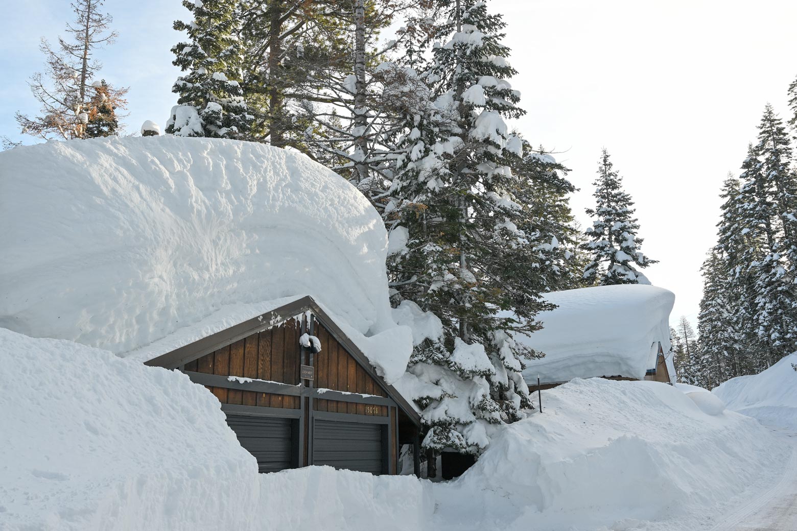 A house covered in several feet of snow.