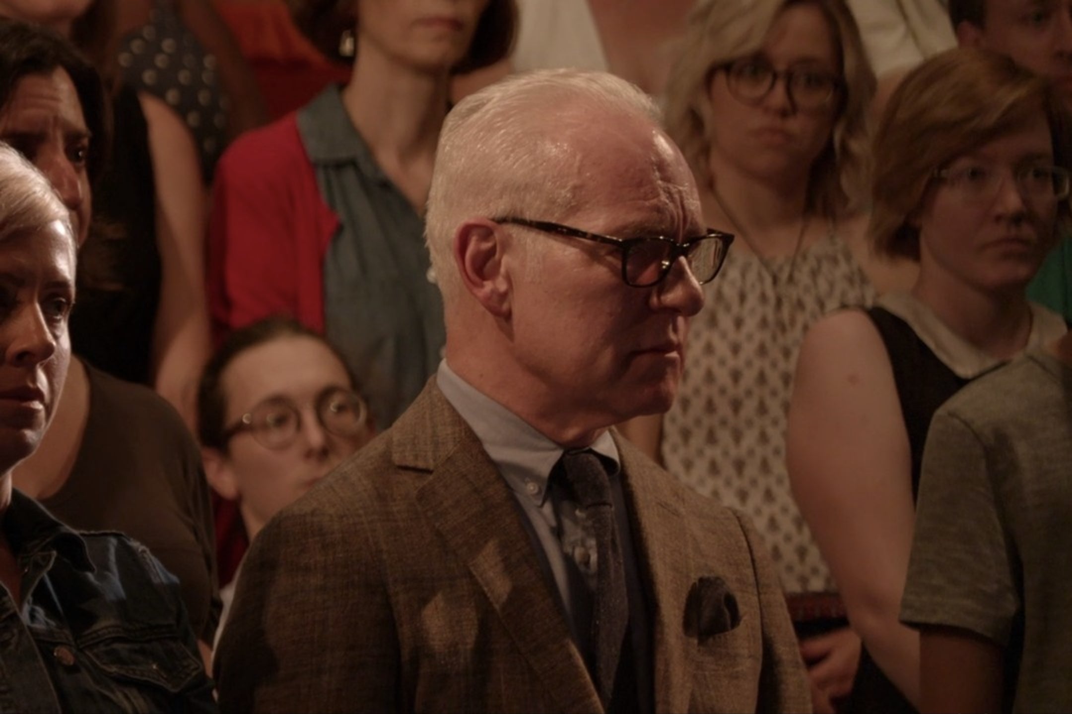 Tim Gunn, standing in a theatrical audience.