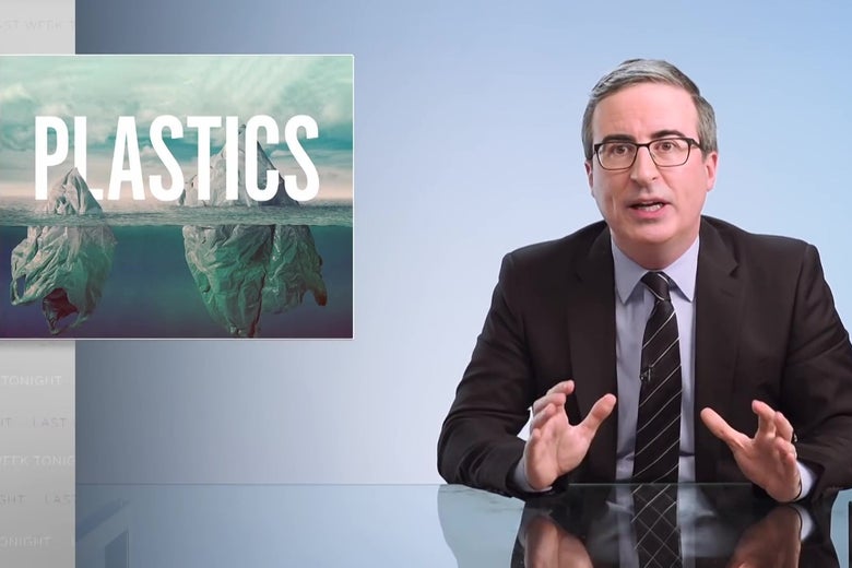 John Oliver sits at a glass anchorperson's desk in front of a graphic reading "Plastics."
