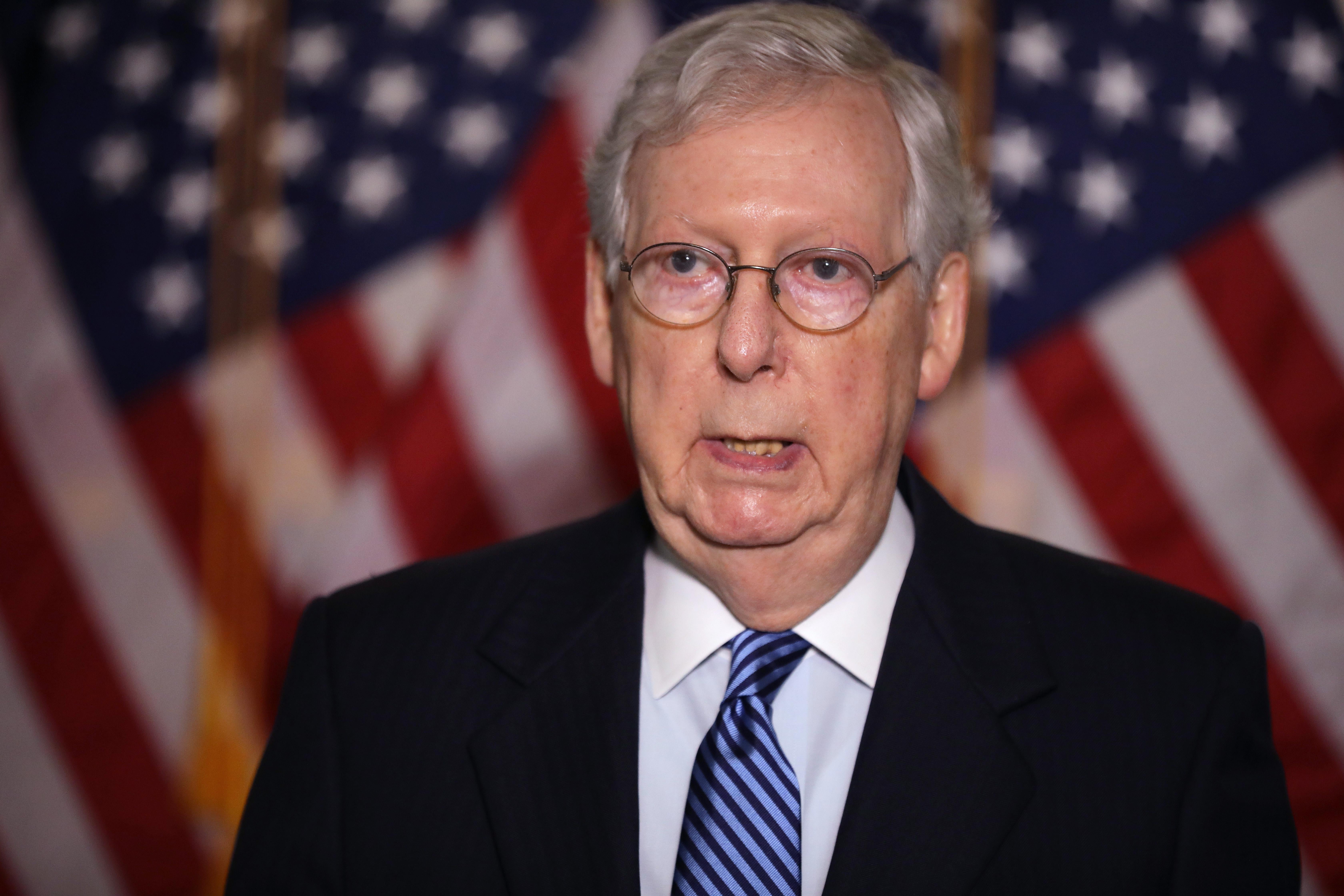 Mitch McConnell in front of an American flag.