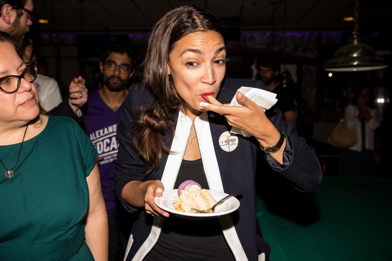 Ocasio-Cortez eats while celebrating her victory with supporters