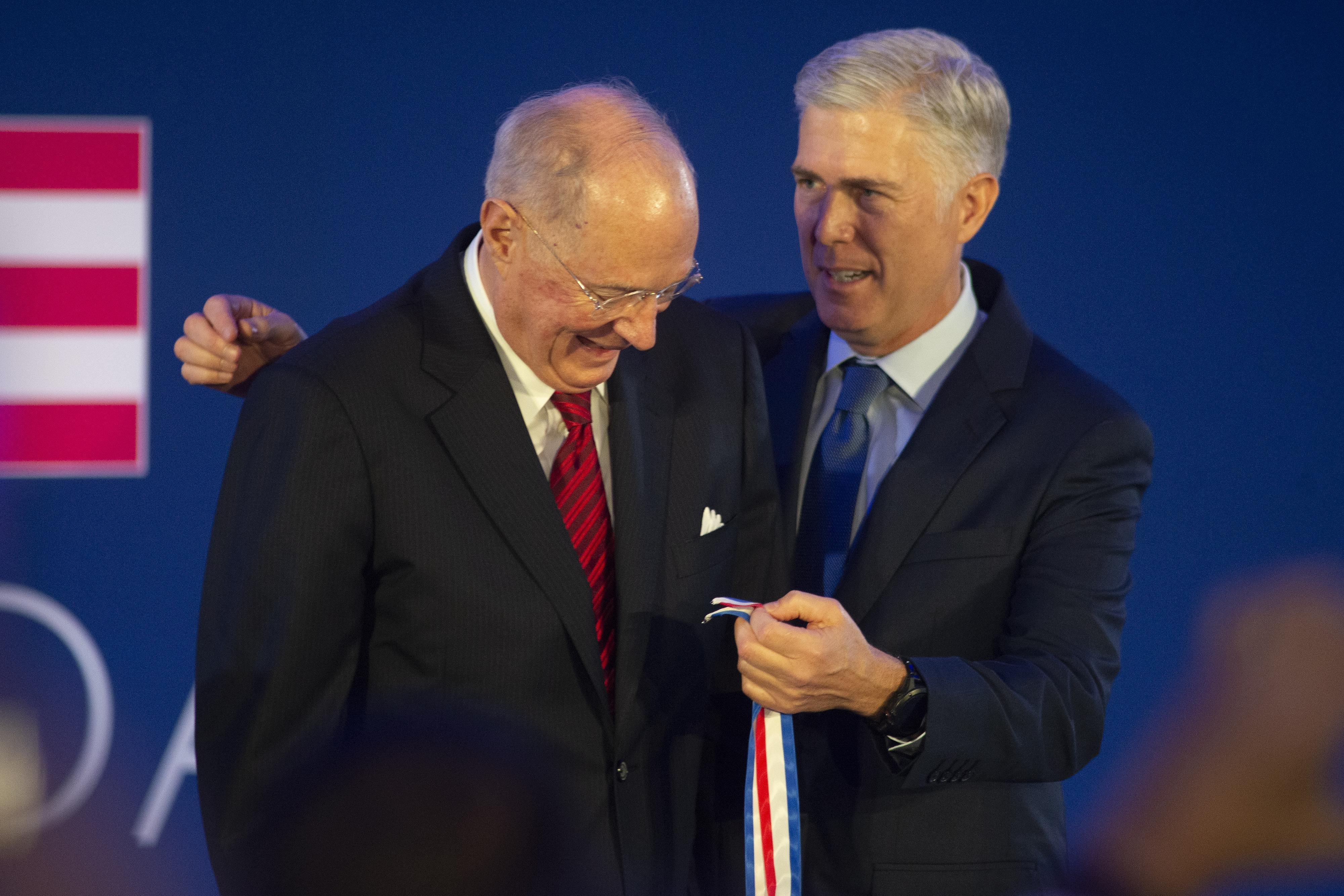 Justice Neil Gorsuch puts the Liberty Medal around retired Justice Anthony Kennedy at a 2019 ceremony.
