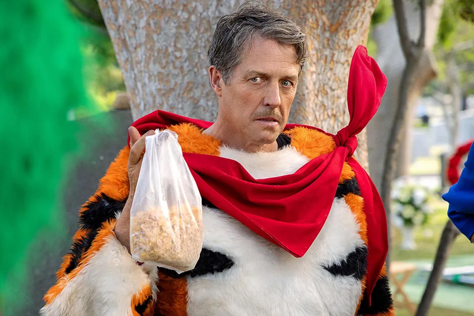 Hugh Grant makes a comical face as Thurl Ravenscroft wearing part of a Tony the Tiger costume.