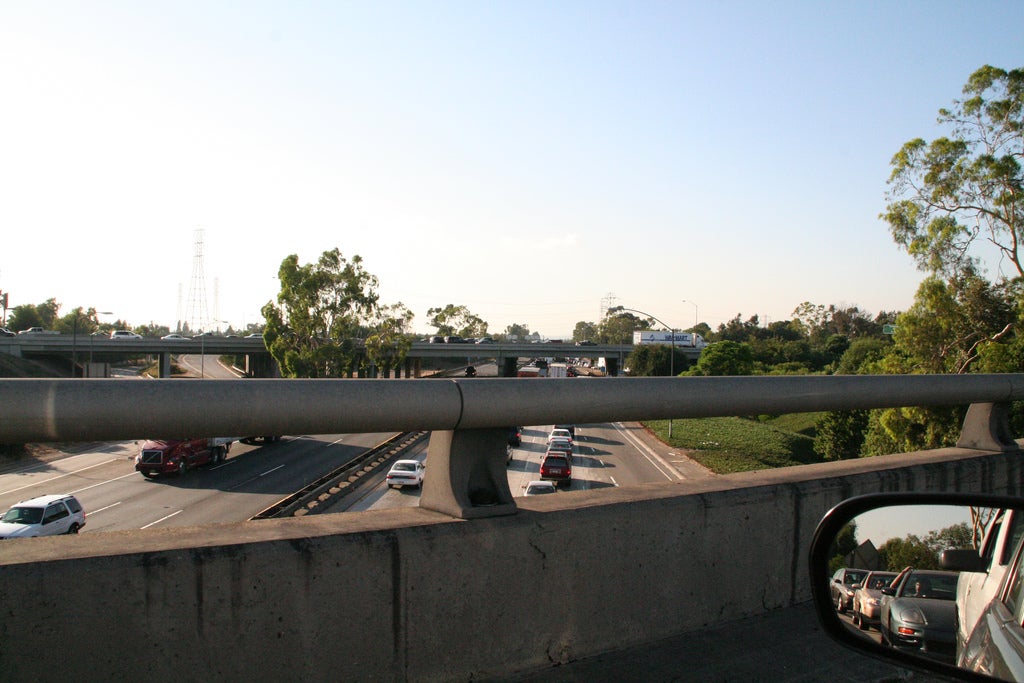 View out a car window over a highway overpass.