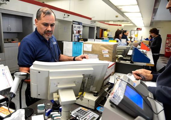 U.S. Postal Service clerk helps a customer. 
