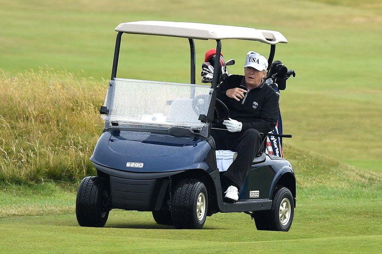 Trump driving a golf cart.