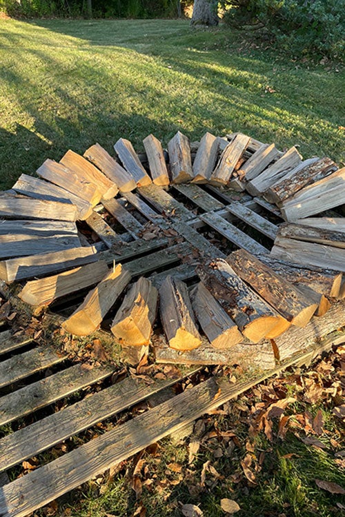 A later stage of holzhausen: a couple of rows of split wood arranged in a circle.