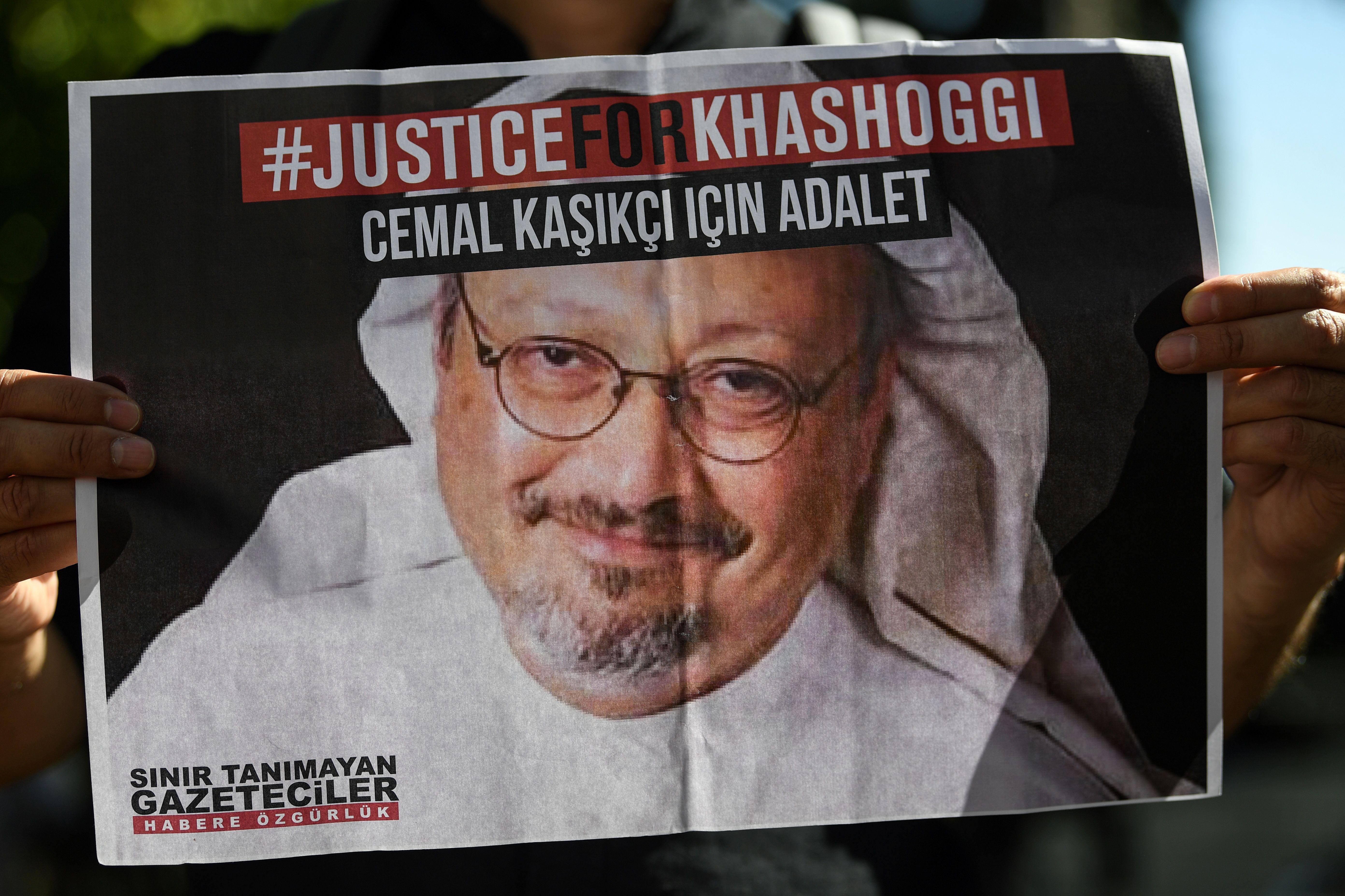 Friends of murdered Saudi journalist Jamal Khashoggi hold posters bearing his picture as they attend an event marking the second-year anniversary of his assassination in front of Saudi Arabia Istanbul Consulate, on October 2, 2020. - Khashoggi, a Washington Post columnist, was killed and dismembered at the Saudi consulate in Istanbul on October 2, 2018, in an operation that reportedly involved 15 agents sent from Riyadh. His remains have not been found. (Photo by Ozan KOSE / AFP) (Photo by OZAN KOSE/AFP via Getty Images)