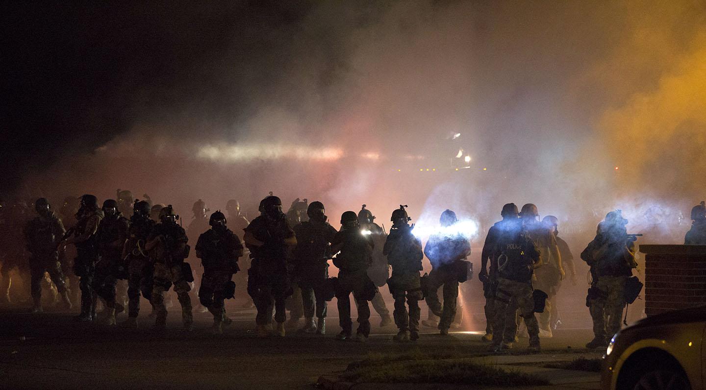 Demonstrators protest the shooting death of teenager Michael Brown on August 13, 2014 in Ferguson, Missouri. Brown was shot and killed by a Ferguson police officer on Saturday. Ferguson, a St. Louis suburb, is experiencing its fourth day of violent protests since the killing.