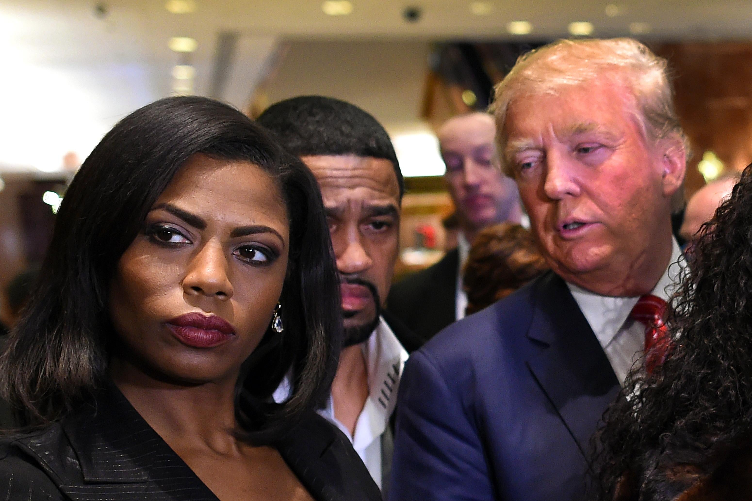 Omarosa Manigault and Donald Trump, among a crowd of people.