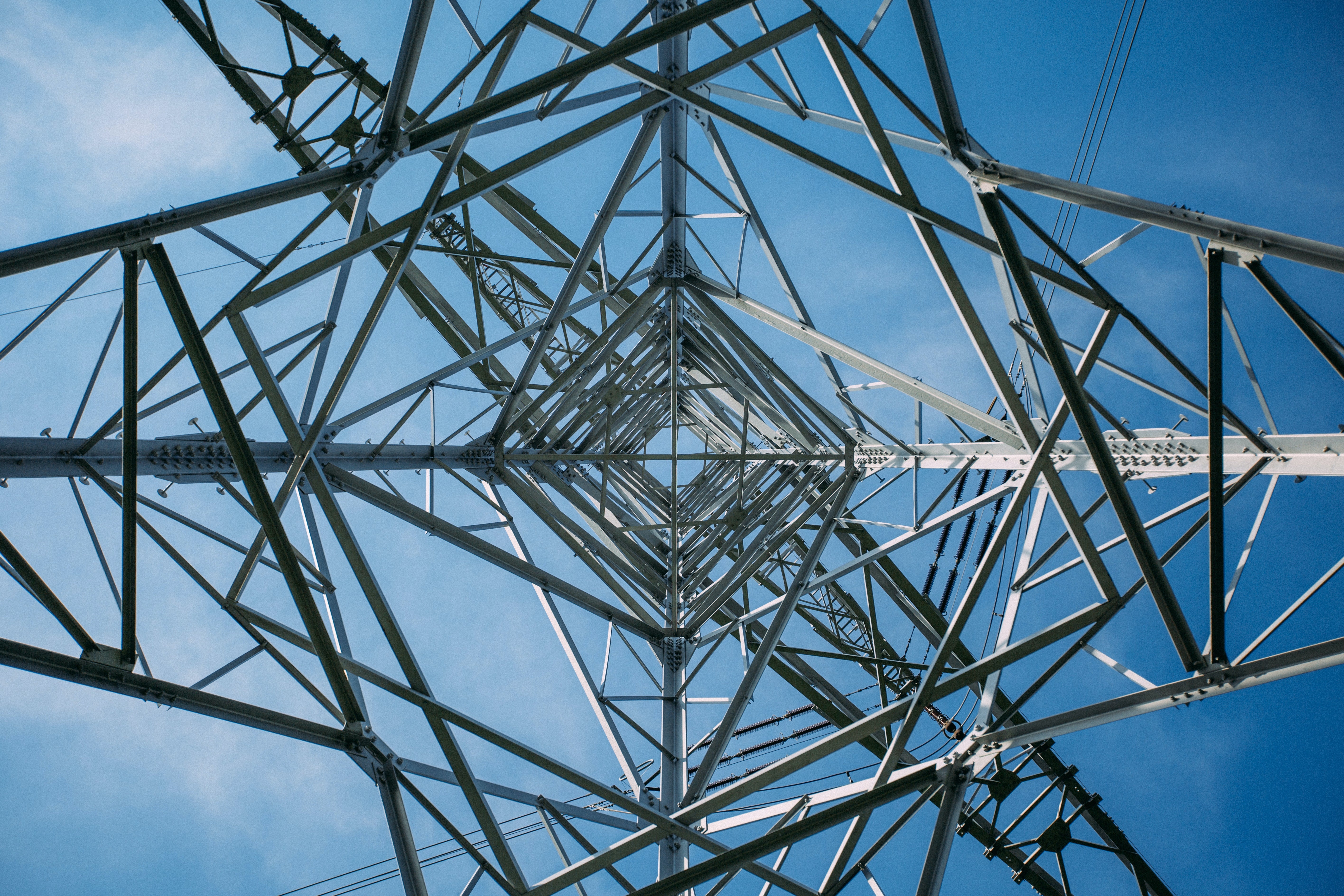 A low-angle view of a transmission tower.