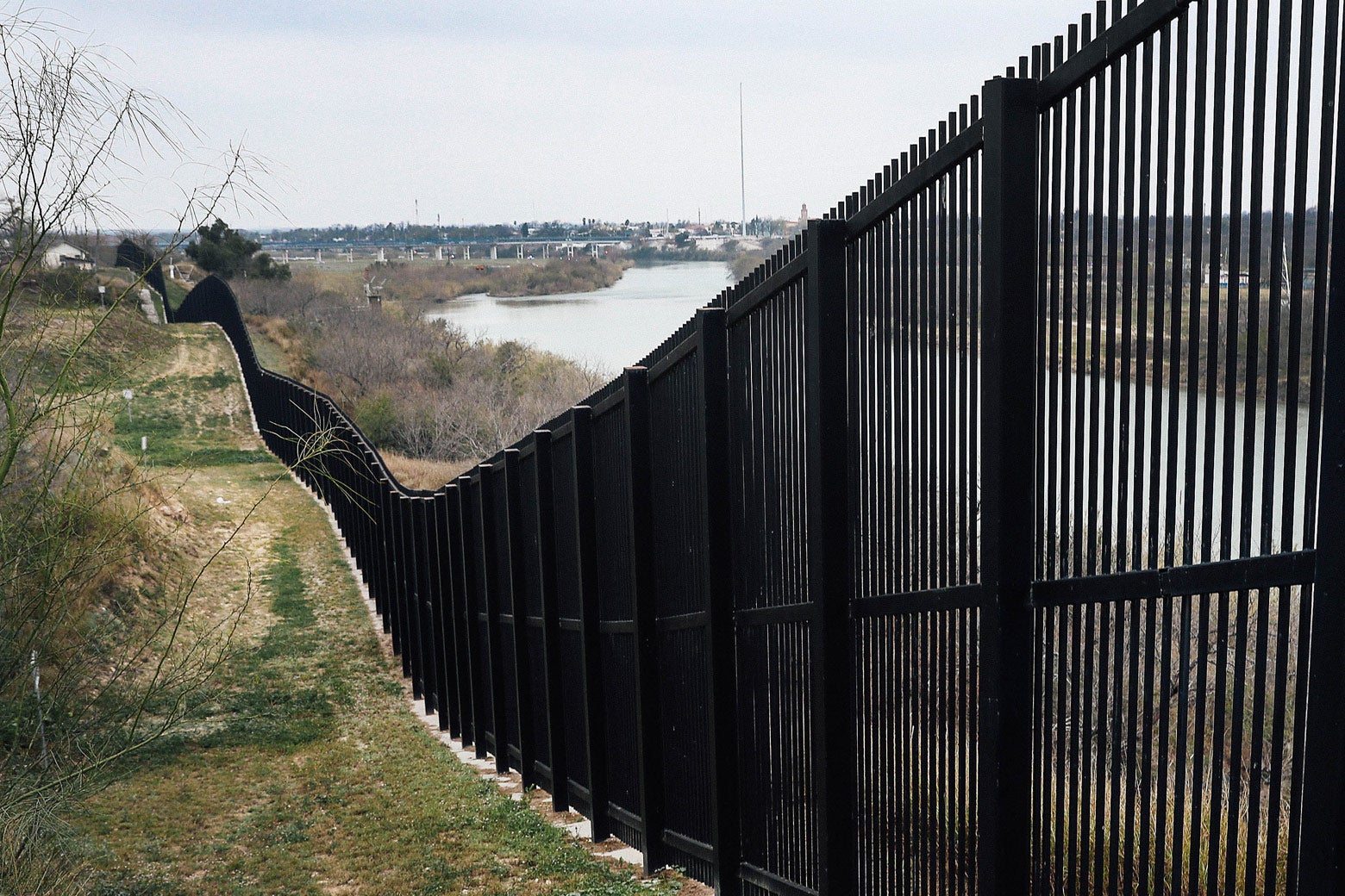 A border fence is seen near the Rio Grande.