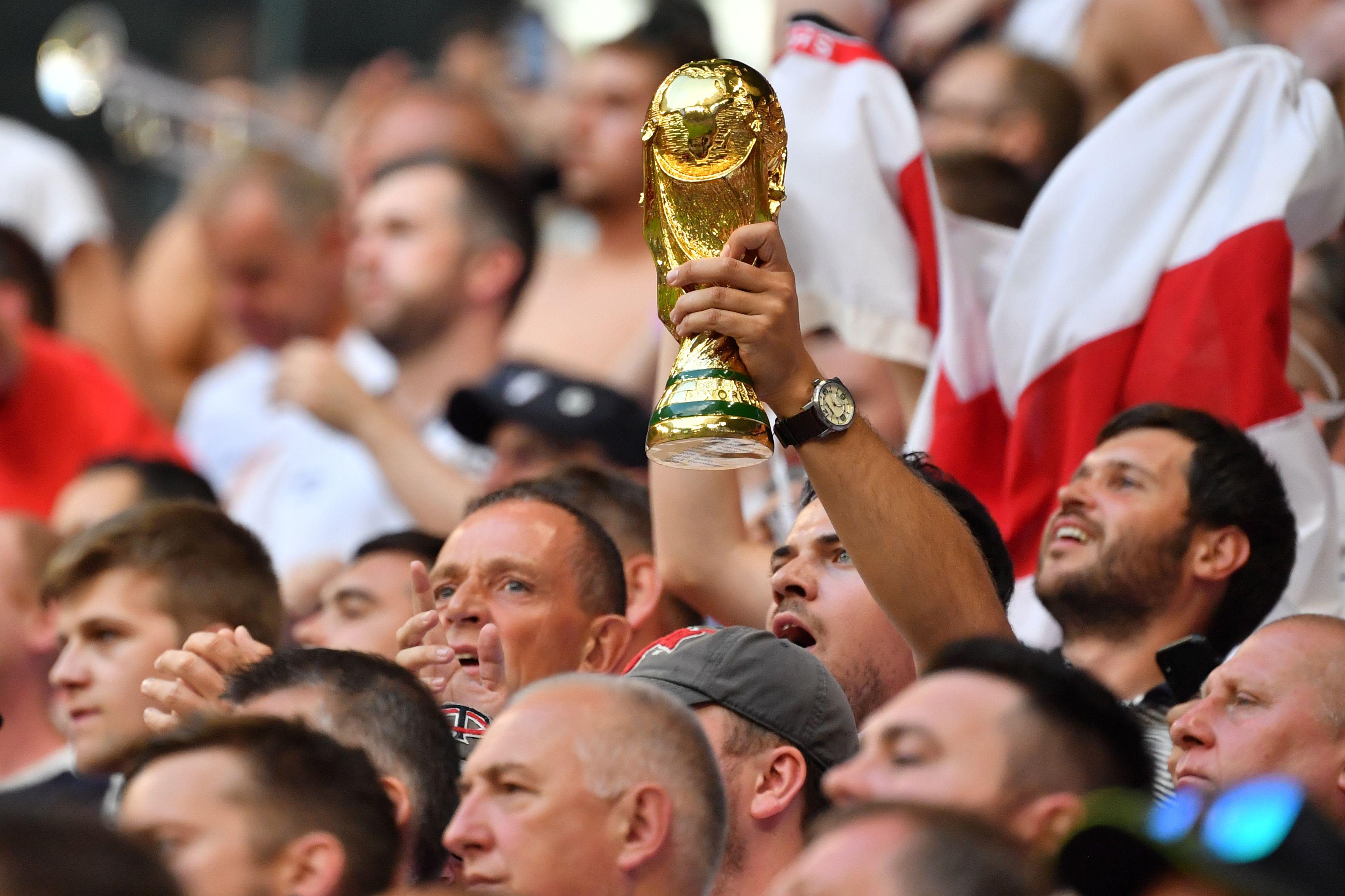 An England fan holds up a replica of the World Cup trophy during the Russia 2018 World Cup quarter-final football match between Sweden and England at the Samara Arena in Samara on July 7, 2018. (Photo by Yuri CORTEZ / AFP) / RESTRICTED TO EDITORIAL USE - NO MOBILE PUSH ALERTS/DOWNLOADS        (Photo credit should read YURI CORTEZ/AFP/Getty Images)