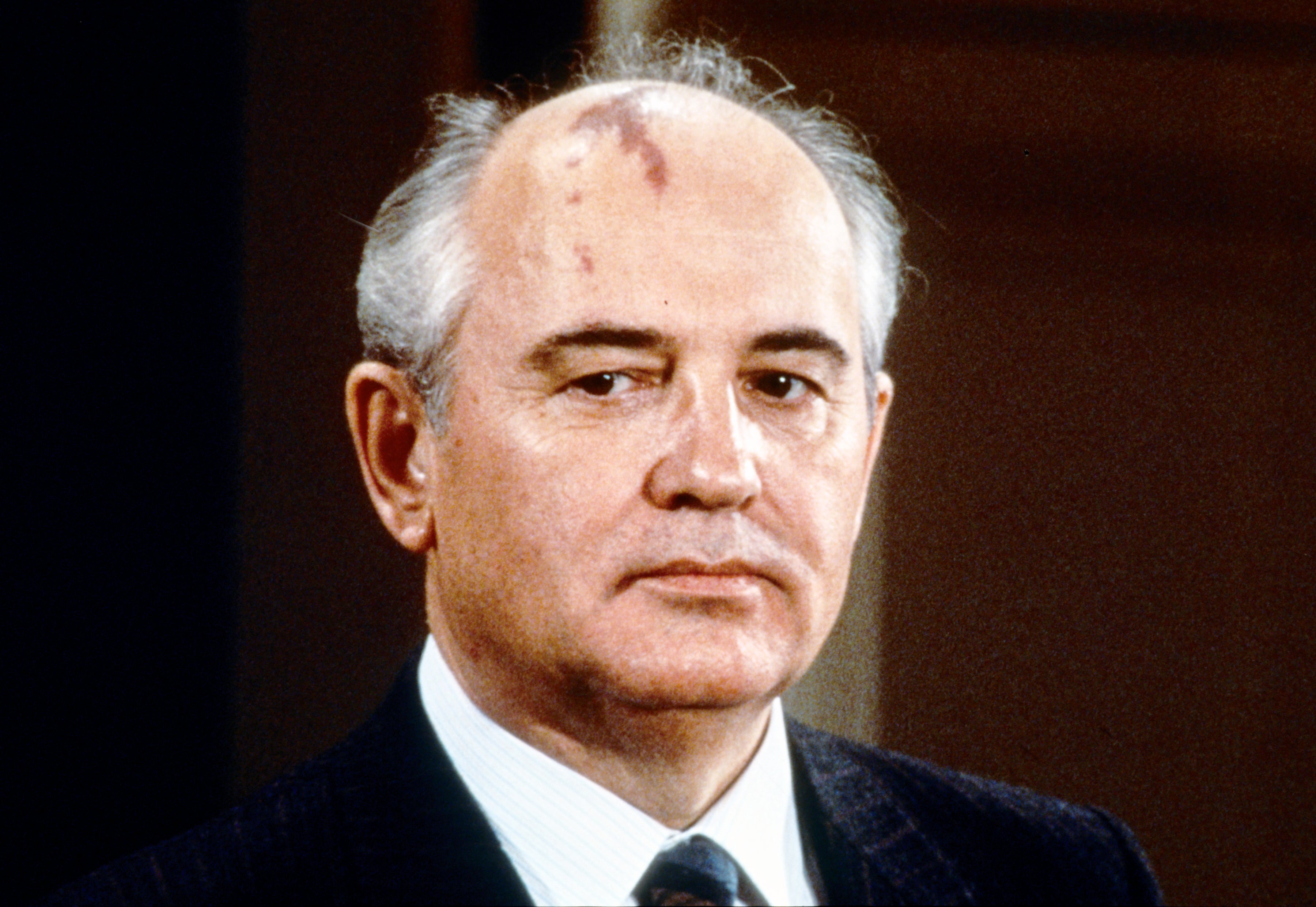 Gorbachev wearing a slight frown. His head splotch is visible.