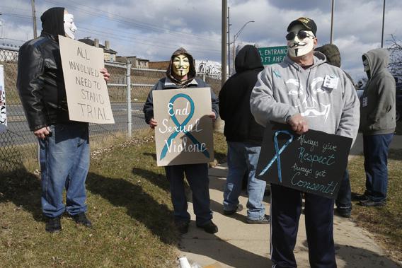 A group of protesters stand outside juvenile court in Steubenville, Ohio, March 14, 2013.
